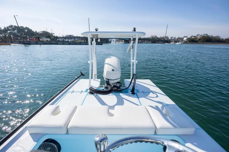 Slide: The Image of 2015 East Cape Fury boat on calm water, featuring a sleek design and outboard motor. - 9