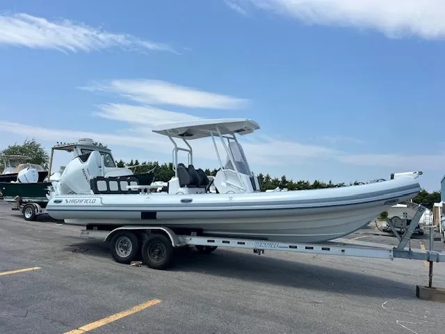 The Image of 2024 Highfield Sport 800 boat on trailer, parked outdoors under a clear sky. - 1