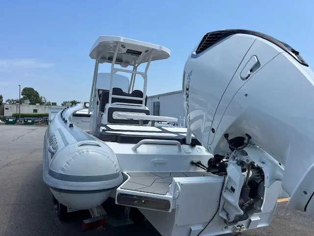 Slide: The Image of 2024 Highfield Sport 800 boat with powerful outboard motor, docked outdoors. - 13