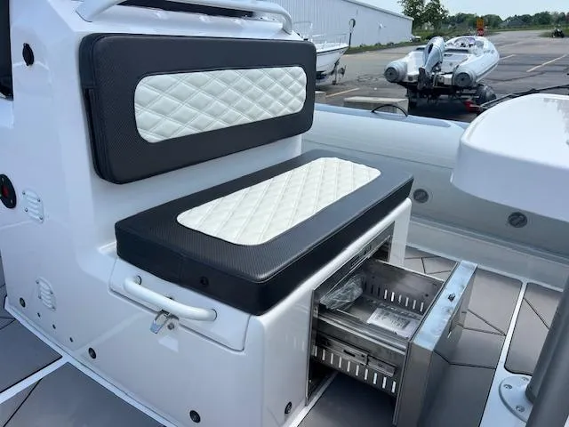 Slide: The Image of 2024 Highfield Sport 800 boat interior with quilted seating and storage compartment. - 14