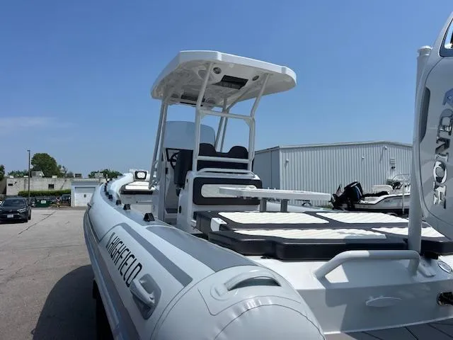 Slide: The Image of 2024 Highfield Sport 800 boat with canopy, docked outdoors on a sunny day. - 17