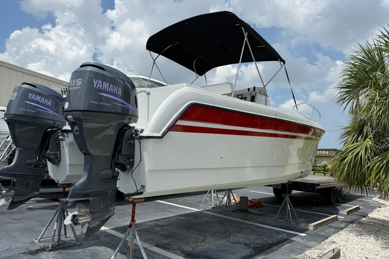 Slide: The Image of 1997 Glacier Bay 260 Canyon Runner with twin Yamaha 115 engines on a trailer. - 2