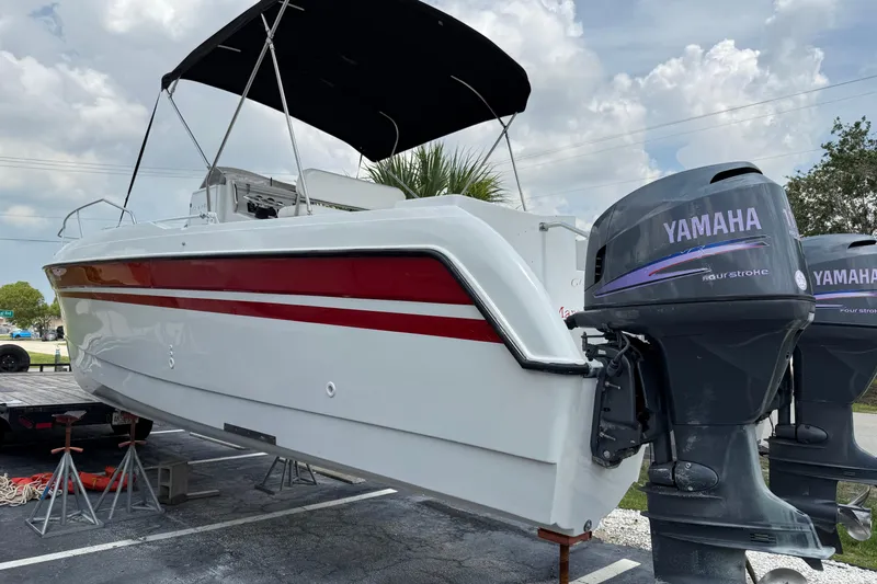 Slide: The Image of 1997 Glacier Bay 260 Canyon Runner boat with Yamaha outboard engines, parked on stands. - 3