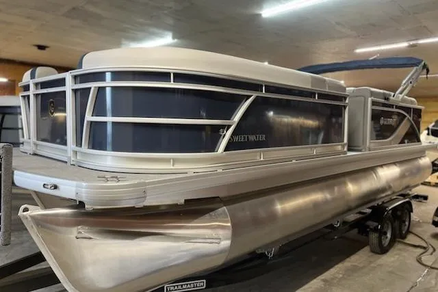 Slide: The Image of 2026 Sweetwater 2286C pontoon boat on water, featuring sleek design and modern amenities. - 1