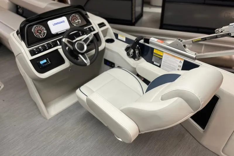 Slide: The Image of Open storage compartment on 2026 Sweetwater 2286C boat, featuring a black interior. - 16