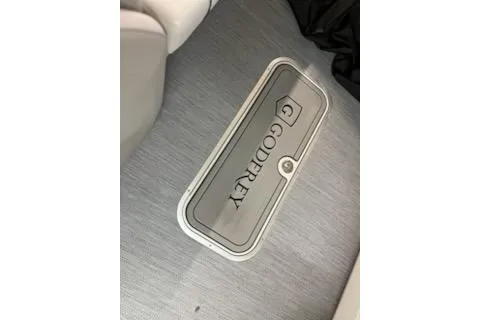 Slide: The Image of Floor compartment on 2026 Sweetwater 2286C boat with Godfrey branding. - 19