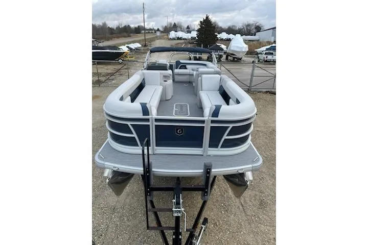 Slide: The Image of 2026 Sweetwater 2286C pontoon boat with spacious seating, displayed on a trailer. - 23