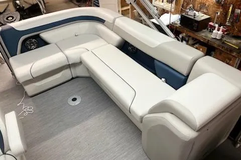 Slide: The Image of Control panel on 2026 Sweetwater 2286C boat interior, featuring switches and a power outlet. - 9