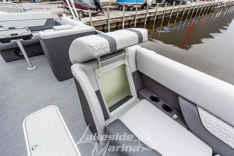Slide: The Image of 2025 Godfrey Monaco 235 SFL boat interior with storage compartment and cup holders. - 16