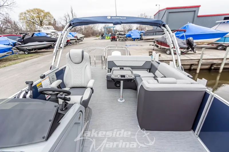 Slide: The Image of 2025 Godfrey Monaco 235 SFL pontoon boat interior at marina dock. - 17