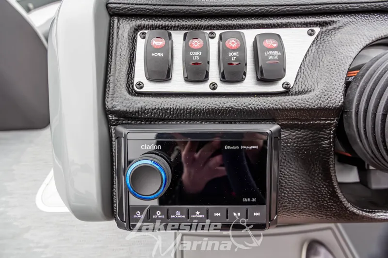 Slide: The Image of Control panel of 2025 Godfrey Monaco 235 SFL with switches and Clarion audio system. - 24