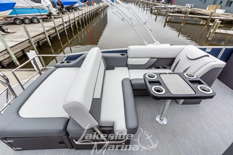 Slide: The Image of 2025 Godfrey Monaco 235 SFL boat interior with luxurious seating and table at Lakeside Marina. - 26