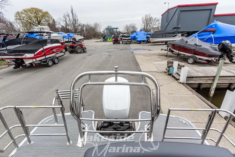 Slide: The Image of 2025 Godfrey Monaco 235 SFL at marina, surrounded by covered boats and equipment. - 33