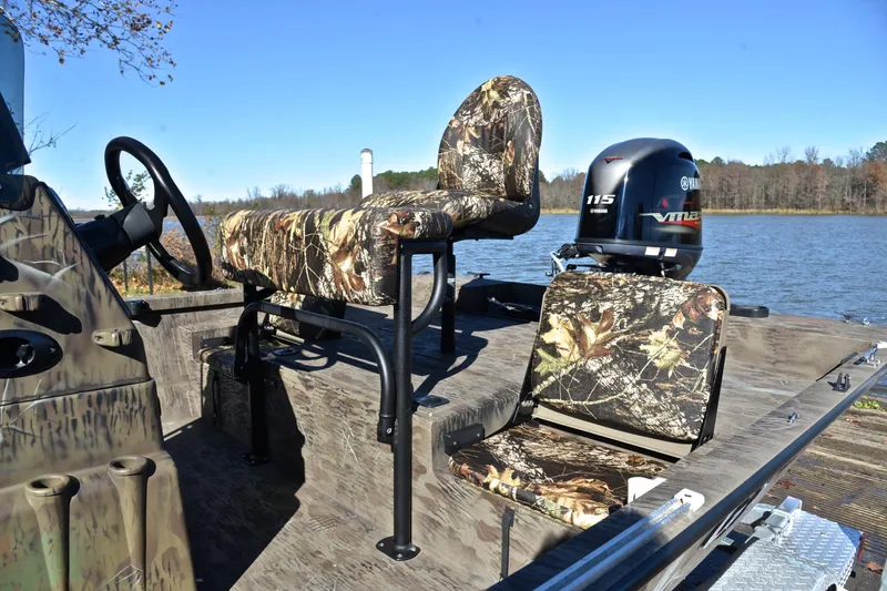 Slide: The Image of 2017 G3 Bay 20 DLX Camo boat with camo seats and Yamaha 115 engine on a lake. - 18