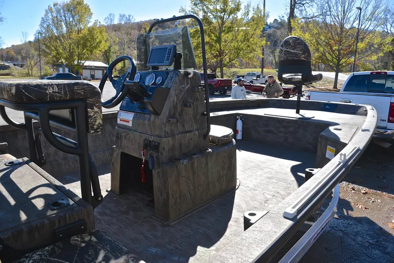 Slide: The Image of 2017 G3 Bay 20 DLX Camo boat with camo design, parked outdoors. - 19