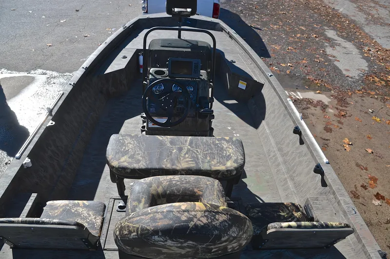 Slide: The Image of 2017 G3 Bay 20 DLX Camo boat interior with camouflage seating and steering console. - 20