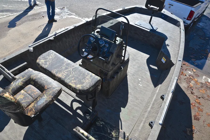 Slide: The Image of 2017 G3 Bay 20 DLX Camo boat interior with camouflage seating and control panel. - 21