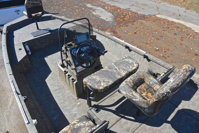 Slide: The Image of 2017 G3 Bay 20 DLX Camo boat interior with camo seats and steering console. - 22