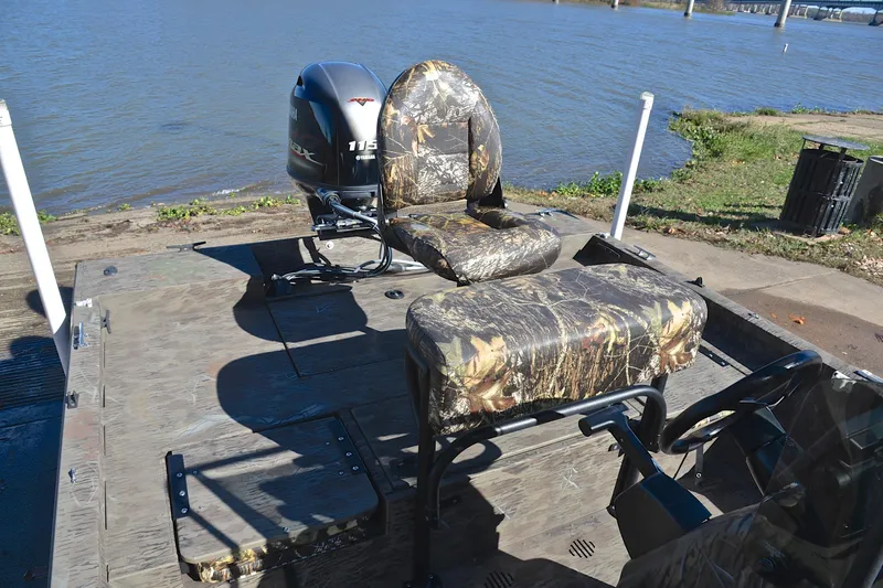 Slide: The Image of 2017 G3 Bay 20 DLX Camo boat with camo seats and Yamaha motor by the water. - 24