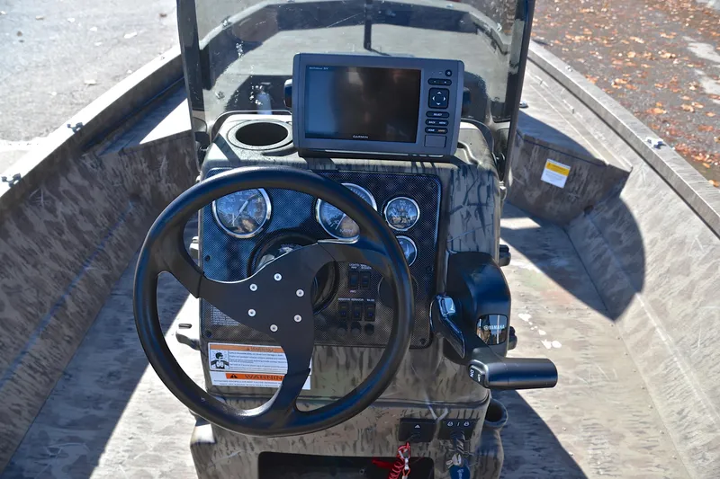 Slide: The Image of 2017 G3 Bay 20 DLX Camo boat dashboard with steering wheel and navigation system. - 25