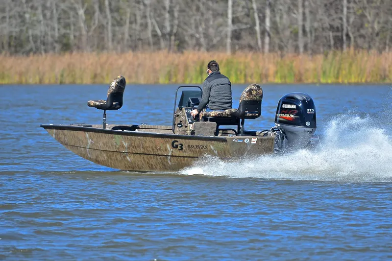 Slide: The Image of 2017 G3 Bay 20 DLX Camo boat speeding on a lake with Yamaha engine. - 4