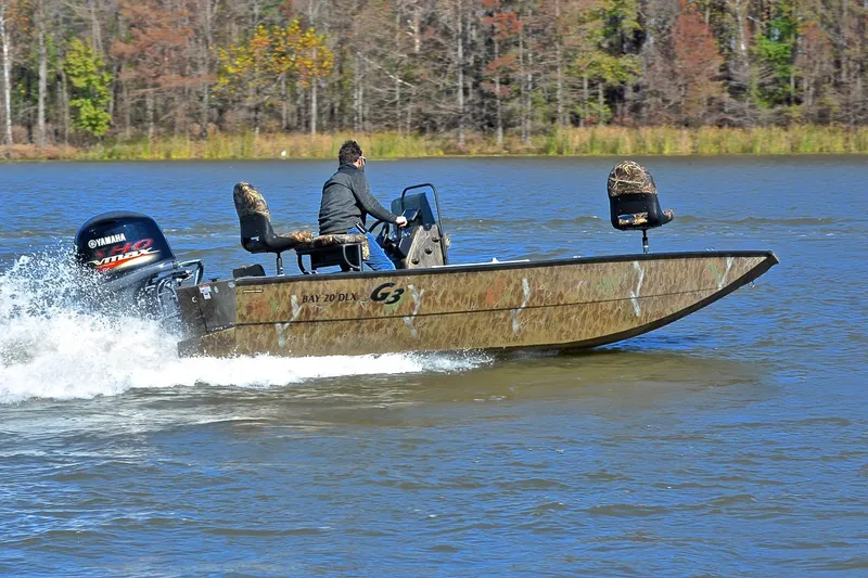Slide: The Image of 2017 G3 Bay 20 DLX Camo boat speeding on a lake with Yamaha engine. - 5