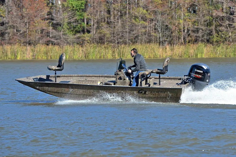 Slide: The Image of 2017 G3 Bay 20 DLX Camo boat speeding on a lake with Yamaha outboard motor. - 6