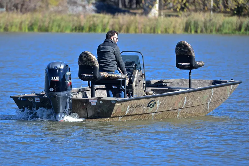 Slide: The Image of 2017 G3 Bay 20 DLX Camo boat on water with Yamaha 115 engine. - 7