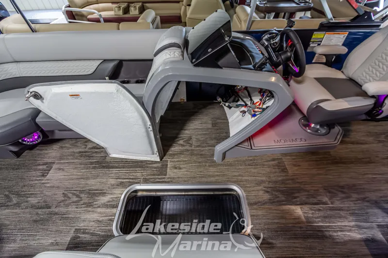Slide: The Image of 2025 Godfrey Monaco 235 SFL boat interior with modern helm and seating at Lakeside Marina. - 12