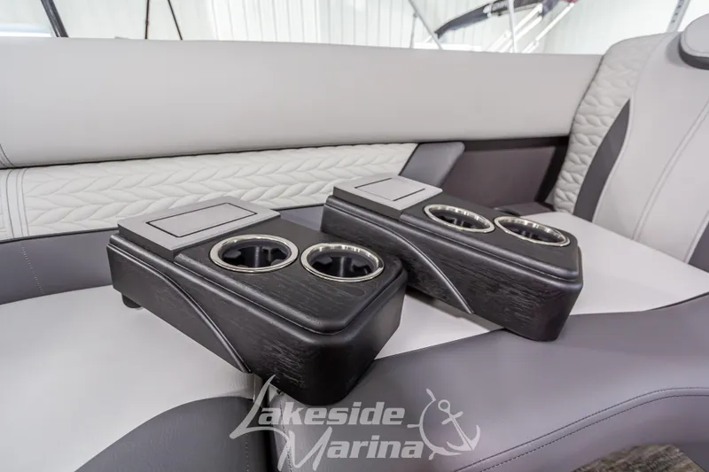 Slide: The Image of Luxury seating with cup holders on 2025 Godfrey Monaco 235 SFL boat interior. - 13
