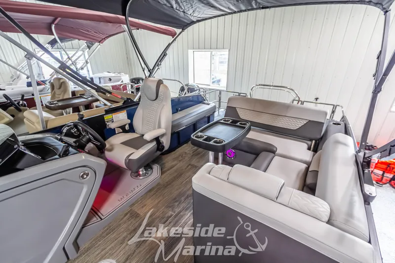 Slide: The Image of 2025 Godfrey Monaco 235 SFL pontoon boat interior with seating and helm, displayed at Lakeside Marina. - 15