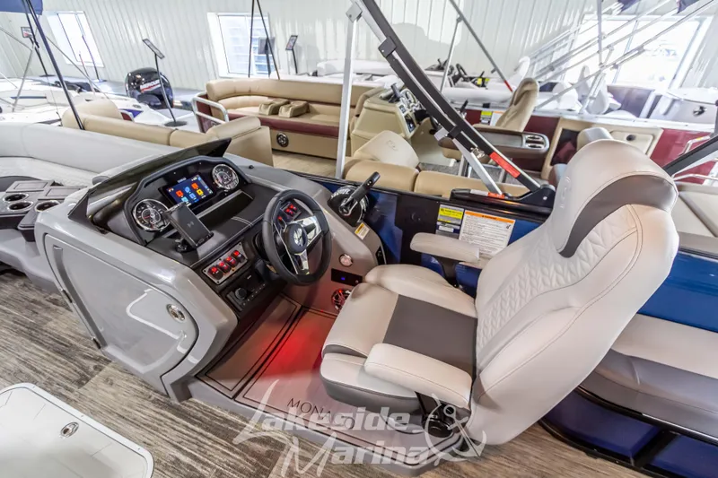 Slide: The Image of 2025 Godfrey Monaco 235 SFL boat interior with modern helm and comfortable seating. - 16