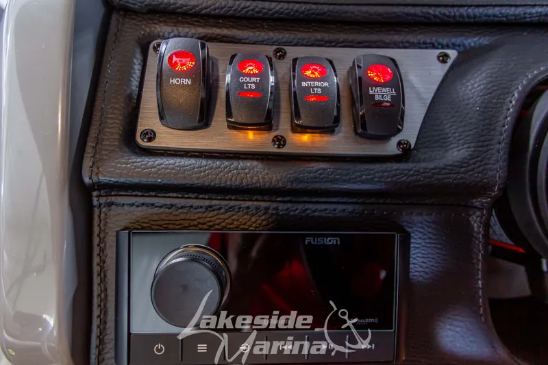 Slide: The Image of Control panel of 2025 Godfrey Monaco 235 SFL with illuminated switches and audio system. - 18