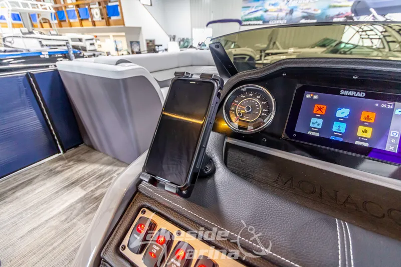 Slide: The Image of Dashboard of 2025 Godfrey Monaco 235 SFL with Simrad display and controls. - 19