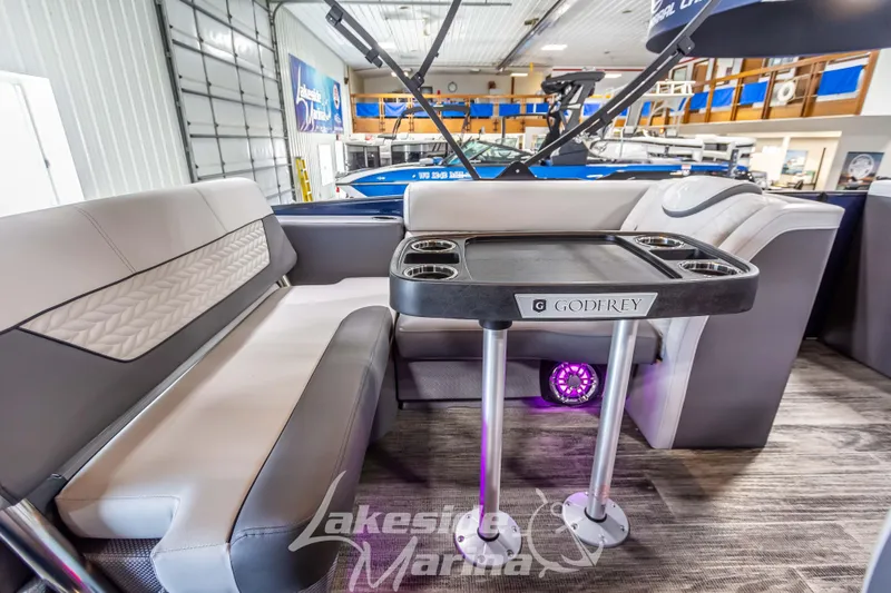 Slide: The Image of Luxurious interior of 2025 Godfrey Monaco 235 SFL pontoon boat with elegant seating and table. - 20