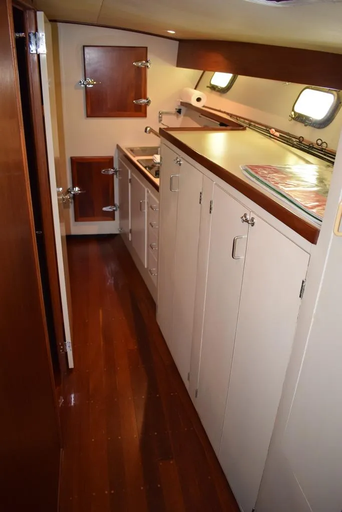 Slide: The Image of Interior of a 1960 Rybovich Sportfisherman yacht with wooden flooring. - 12