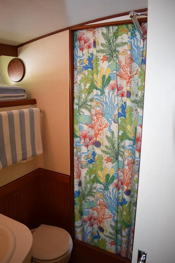 Slide: The Image of 1960 Rybovich Sportfisherman bathroom with colorful shower curtain. - 18