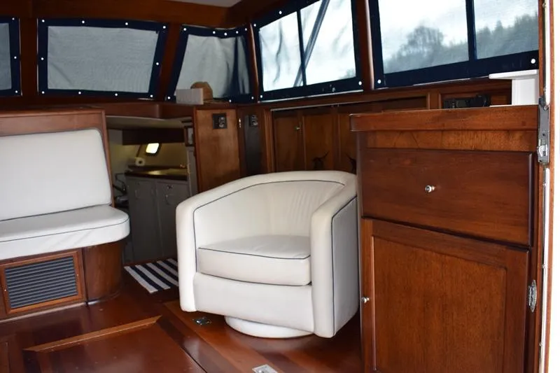 Slide: The Image of Interior of a 1960 Rybovich Sportfisherman with wooden furnishings and white seating. - 2
