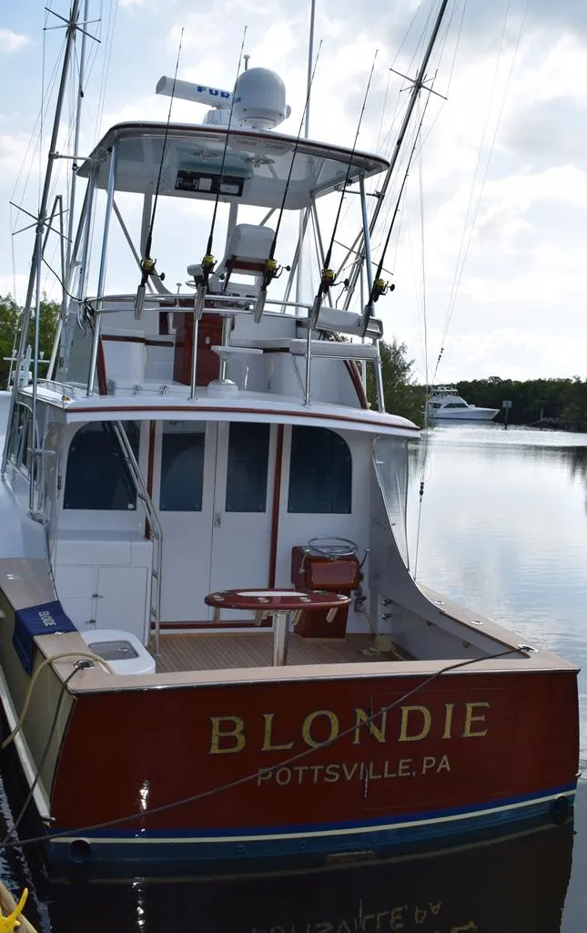 Slide: The Image of 1960 Rybovich Sportfisherman boat on water, rear view. - 30