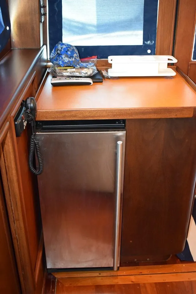 Slide: The Image of 1960 Rybovich Sportfisherman interior with mini fridge and phone. - 5