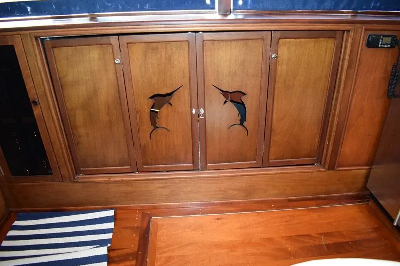 Slide: The Image of Wooden cabinets with fish carvings on a 1960 Rybovich Sportfisherman boat. - 8