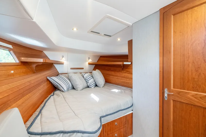 Slide: The Image of Luxurious cabin interior of 2026 MJM 38RS yacht with wooden accents and cozy bedding. - 11
