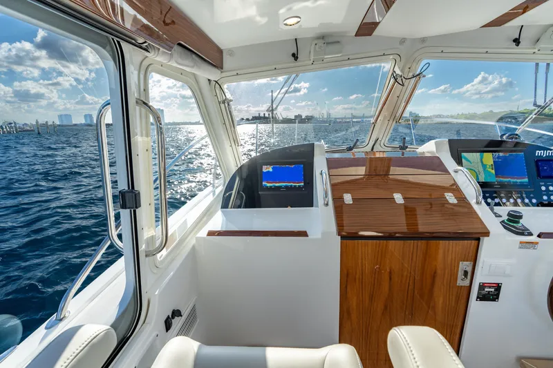Slide: The Image of Interior view of 2026 MJM 38RS yacht cockpit with navigation equipment and ocean view. - 4