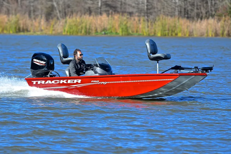The Image of 2024 Tracker Pro 170 boat cruising on a lake with a Mercury engine. - 1