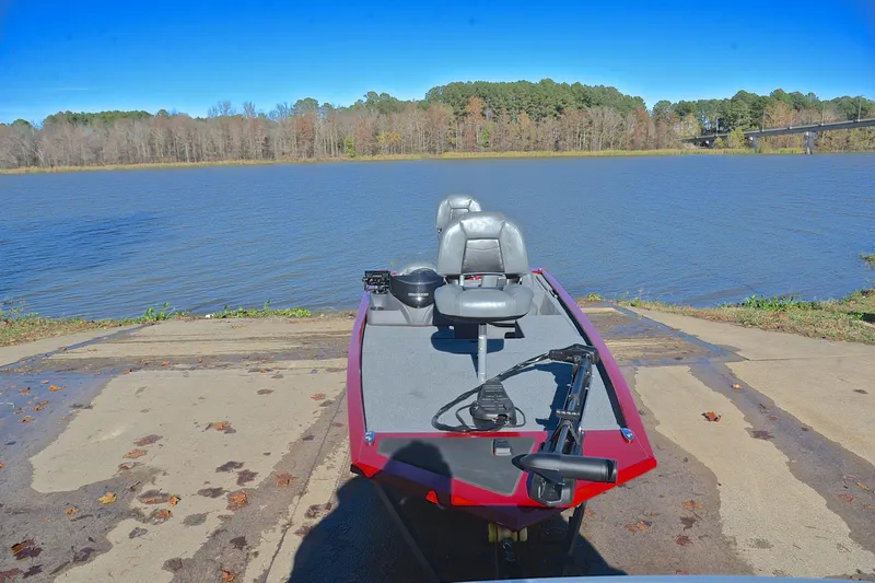 Slide: The Image of 2024 Tracker Pro 170 boat on a ramp by a scenic lake. - 17