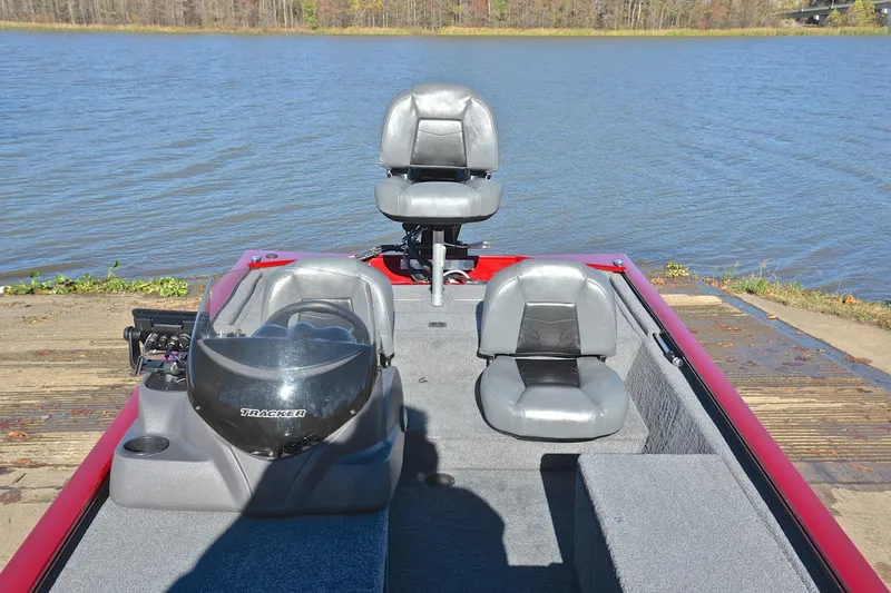 Slide: The Image of 2024 Tracker Pro 170 boat with gray seats on a lake dock. - 23