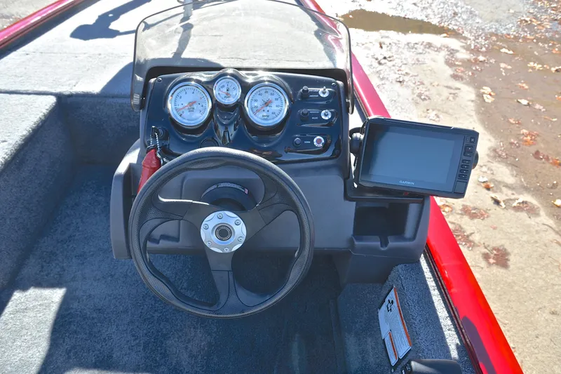 Slide: The Image of 2024 Tracker Pro 170 boat dashboard with steering wheel and Garmin display. - 24