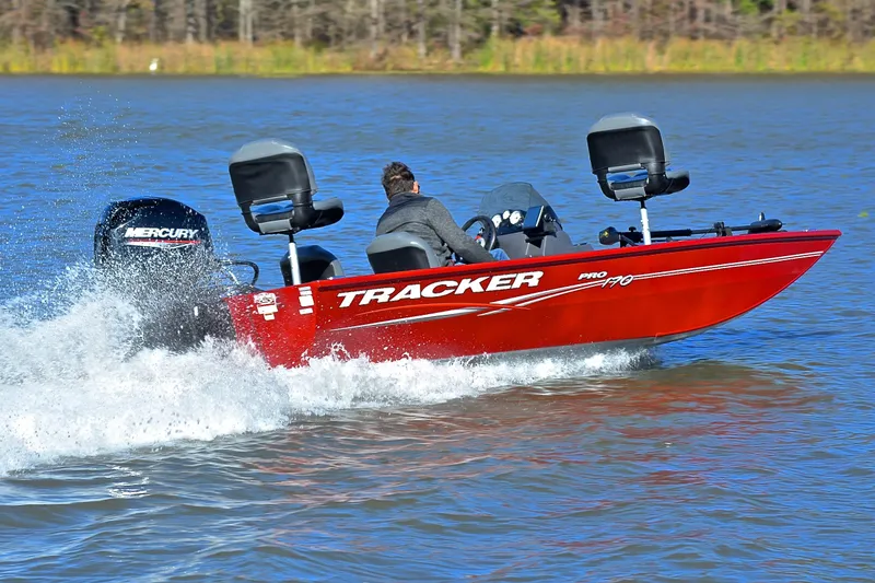 Slide: The Image of 2024 Tracker Pro 170 boat speeding on a lake with a Mercury engine. - 5