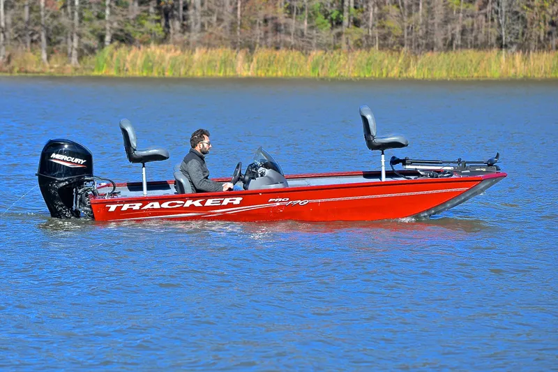 Slide: The Image of 2024 Tracker Pro 170 boat on a lake, featuring a Mercury outboard motor. - 7