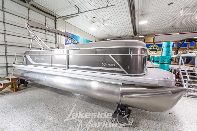 The Image of 2025 Godfrey Sweetwater 2286 FSX pontoon boat in showroom, sleek design, silver finish. - 1